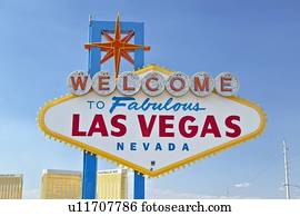 Colorful sign reads “Welcome to Fabulous Las Vegas, Nevada” in daytime with blue sky