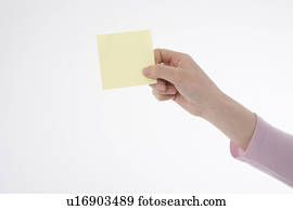 Woman's hand holding memo Woman's hand holding memo