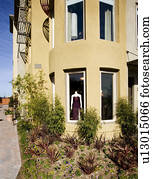 Exterior shot of yellow stucco store 