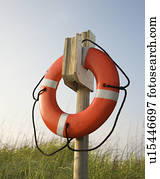 Life preserver hanging on post on beach on Bald Head Island, North Carolina