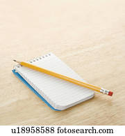 Pencil on top of open spiral bound notepad Pencil on top of open spiral bound notepad