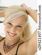 Woman holding up hair smiling