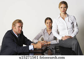 Three businesspeople at a table.