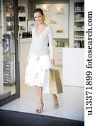 Woman on a shopping trip leaving a store
