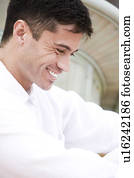 Portrait of a man with dark hair, smiling