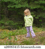 Teenage girl standing with her hands behind her back Stock Image ...