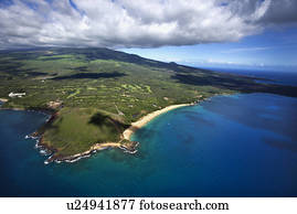 Aerial of coastline with sandy beach and crater and Pacific ocean in Maui, Hawaii.