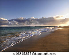 Waves lapping on the beach at dusk