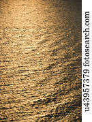 Sun reflecting golden on Atlantic ocean.