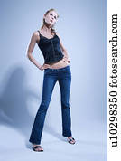 Full length studio portrait of young woman.