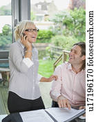 Couple conduct business over the phone Couple conduct business over the phone