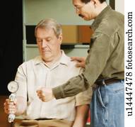 An occupational therapist working with a senior businessman