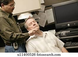 An occupational therapist working with a senior businessman