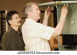 An occupational therapist working with a senior businessman