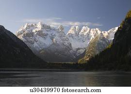 Snow capped mountains on lake