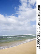 Landscape of waves lapping on beach.
