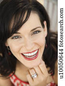 Mid-adult Caucasian woman smiling wearing wedding ring.