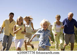 Three Generations of family running by lake