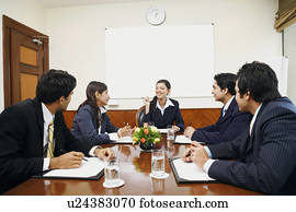 Five business executives at a meeting in a conference room
