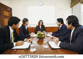 Five business executives at a meeting in a conference room