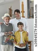 Three generations painting in art studio