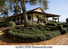 Exterior of Spanish style home and landscape