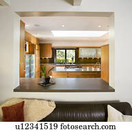 Leather Sofa in Modern Living Room with Cutout to Kitchen