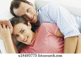 Happy couple embrace on sofa Happy couple embrace on sofa