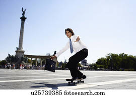 Businessman on skateboard in Hero Square.