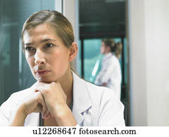 Portrait of female doctor with female doctor in background. Portrait of female doctor with female doctor in background.