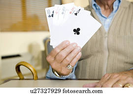 An elderly man playing cards