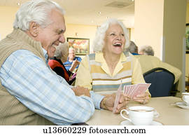 Two residents in a retirement home playing cards