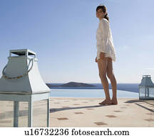 A woman standing by a pool