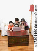 Mid adult man using a laptop with his son and daughter beside him