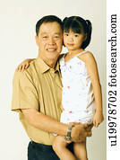 Portrait of a senior man carrying his granddaughter