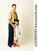 Portrait of a senior man standing with his granddaughter