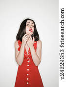 Woman making facial expression while popping a zit 