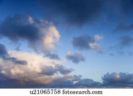 Colorful cumulus clouds in sky.