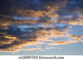 Colorful cumulus clouds in sky.