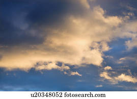 Colorful cumulus clouds in sky.