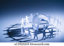 Cutout paper people standing around globe holding hands.