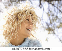 Woman with curly blonde hair smiling 