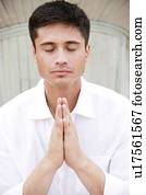 Portrait of a man with dark hair, meditating