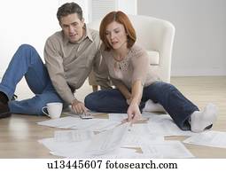 Couple with paperwork on floor