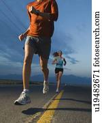 Couple in athletic gear running