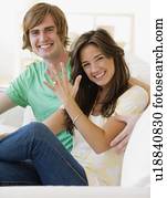 Engaged couple showing off engagement ring