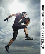 Low angle view of football player jumping