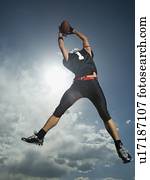 Low angle view of football player jumping
