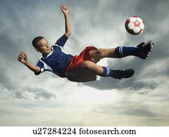 Low angle view of soccer player jumping