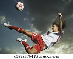 Low angle view of soccer player jumping Low angle view of soccer player jumping